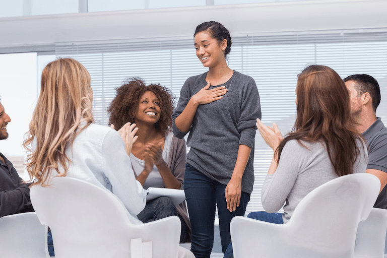 woman feeling relieved after sharing her mental health problems in a group therapy session